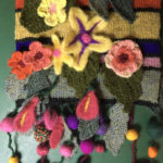Striped scarf with felt and crochet embellishments