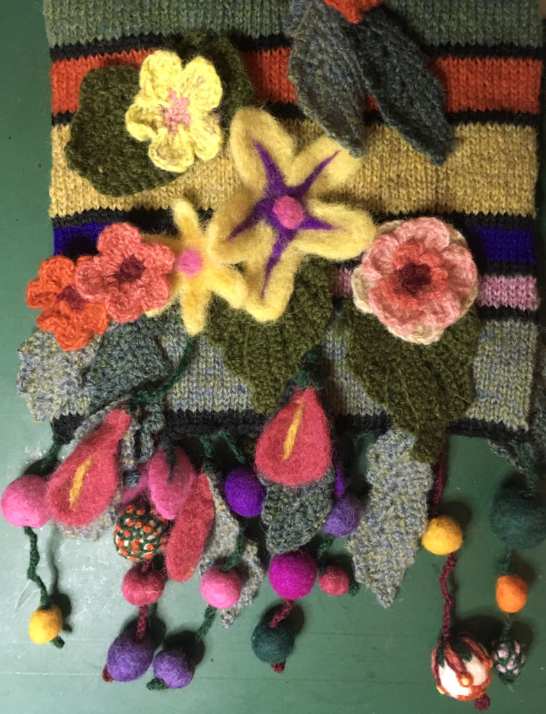 Striped scarf with felt and crochet embellishments