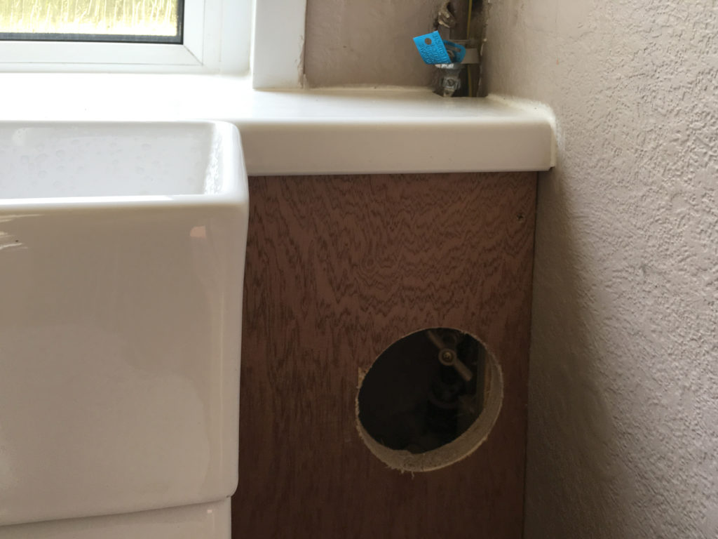 Hole in new panel for access to mains tap
