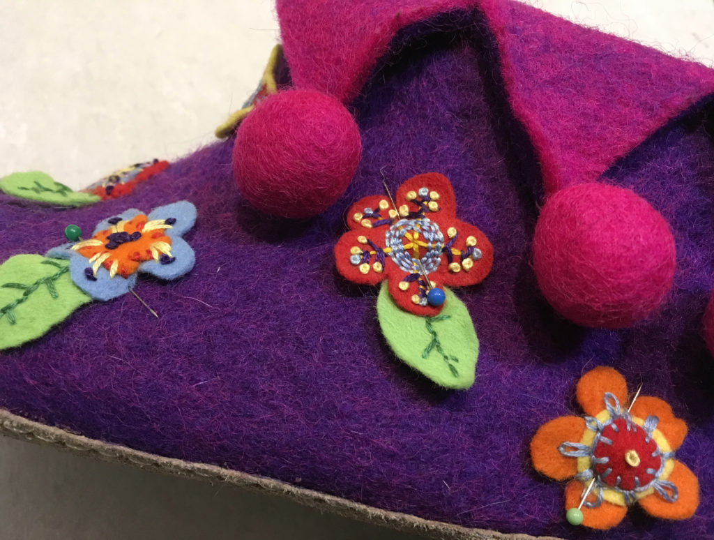 Pinning the flowers on the slippers