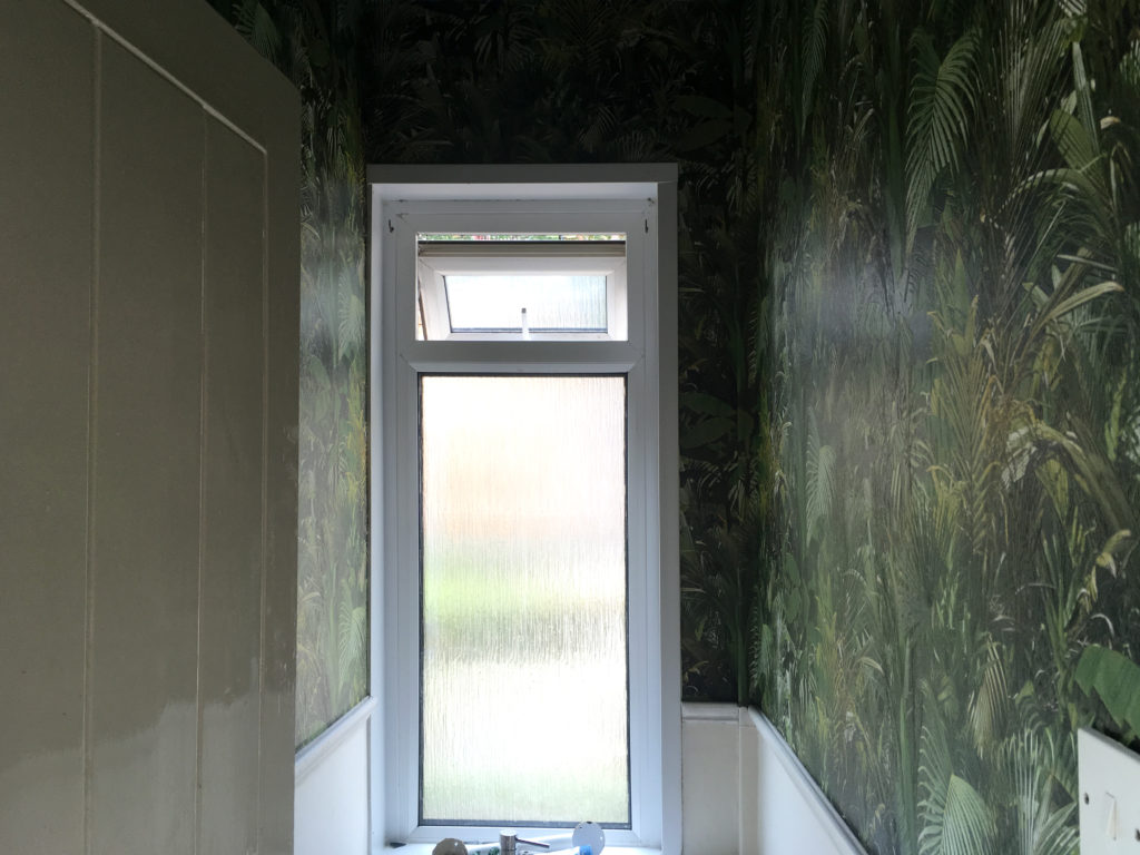 The papering of the walls of the downstairs loo complete